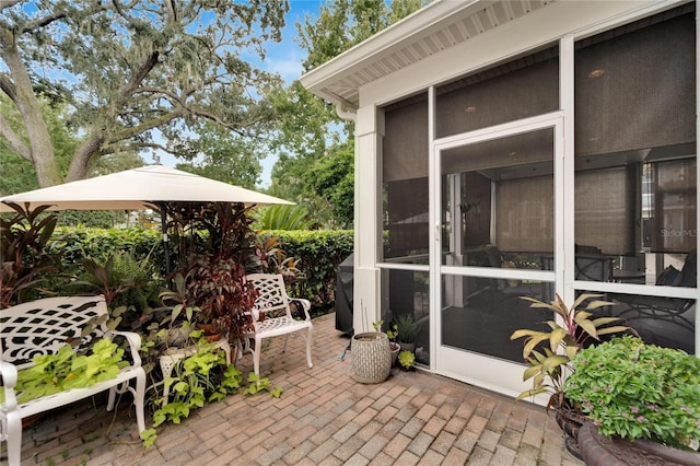 view of patio featuring a sunroom