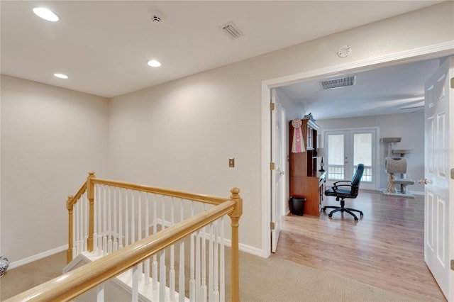 hallway featuring visible vents, french doors, an upstairs landing, and recessed lighting