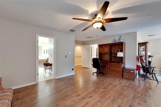 office space featuring visible vents, light wood-style flooring, and baseboards