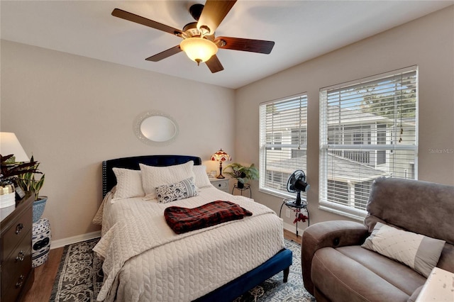 bedroom featuring ceiling fan, wood finished floors, and baseboards