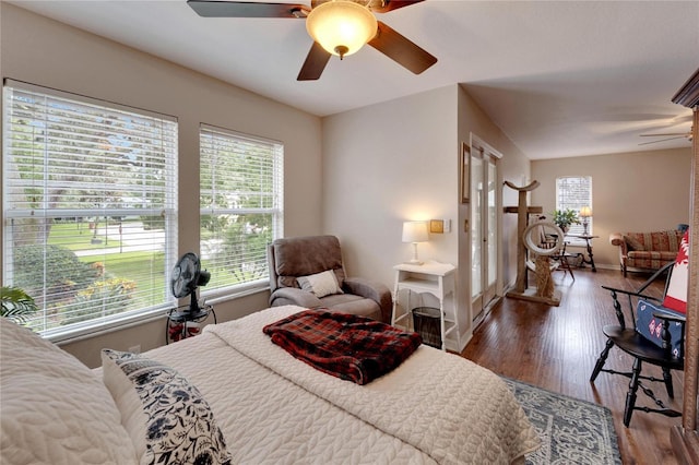 bedroom featuring ceiling fan, baseboards, and wood finished floors