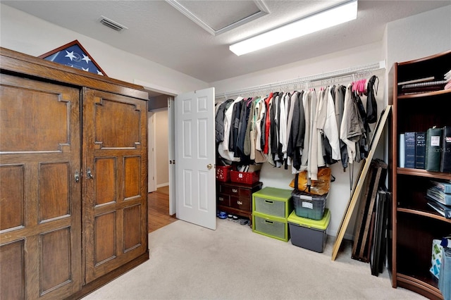 spacious closet with visible vents and light carpet