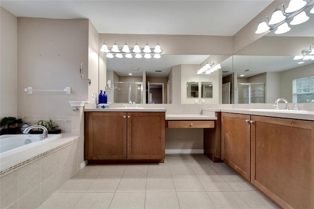 bathroom featuring a stall shower, tile patterned flooring, a garden tub, and a sink