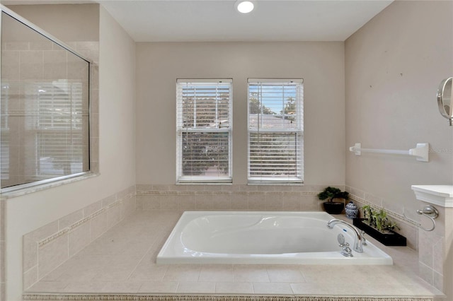 bathroom with a garden tub and a shower stall