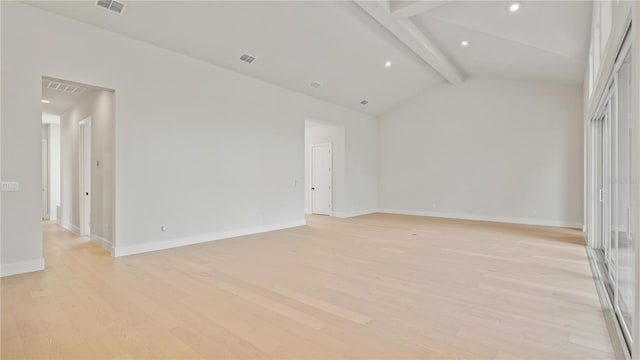 empty room featuring beam ceiling, light hardwood / wood-style flooring, and high vaulted ceiling