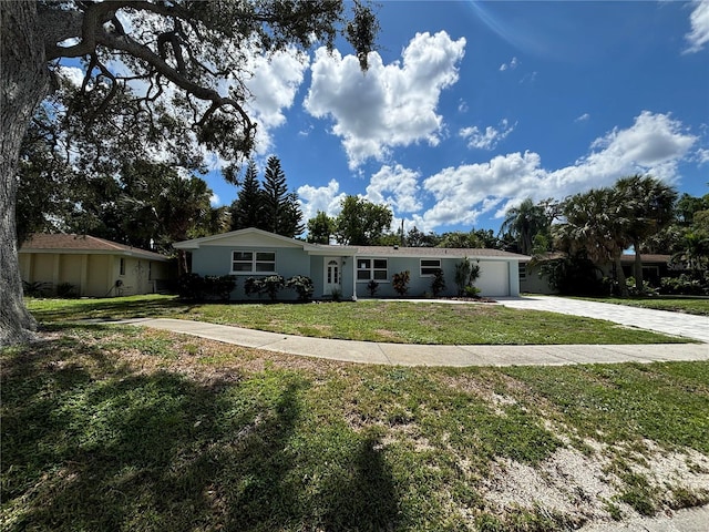 ranch-style house with a garage and a front lawn