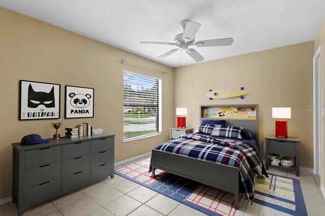 tiled bedroom featuring a textured ceiling and ceiling fan