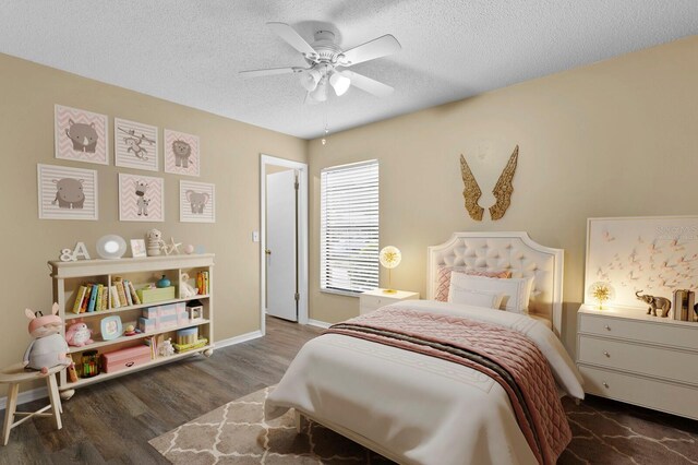 bedroom with ceiling fan, dark hardwood / wood-style floors, and a textured ceiling