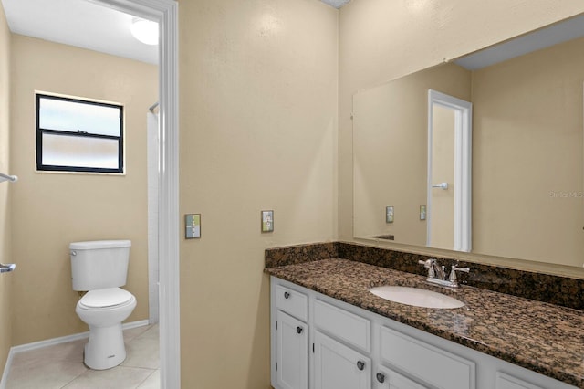 bathroom featuring toilet, vanity, and tile patterned floors