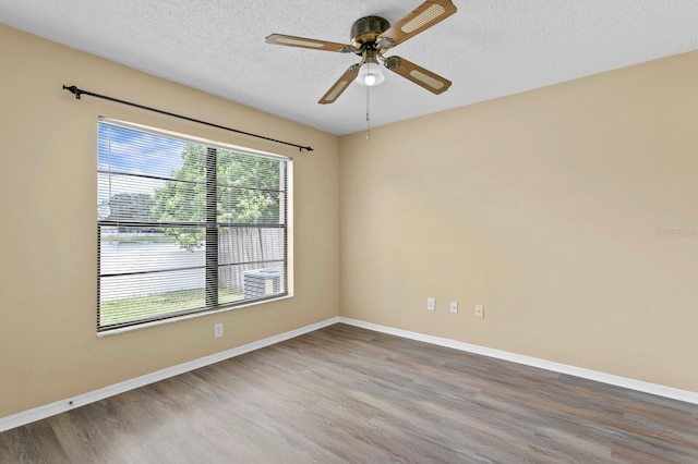 spare room with ceiling fan, hardwood / wood-style flooring, and a textured ceiling