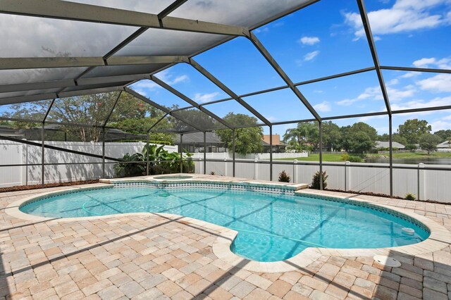 view of pool featuring glass enclosure and a patio