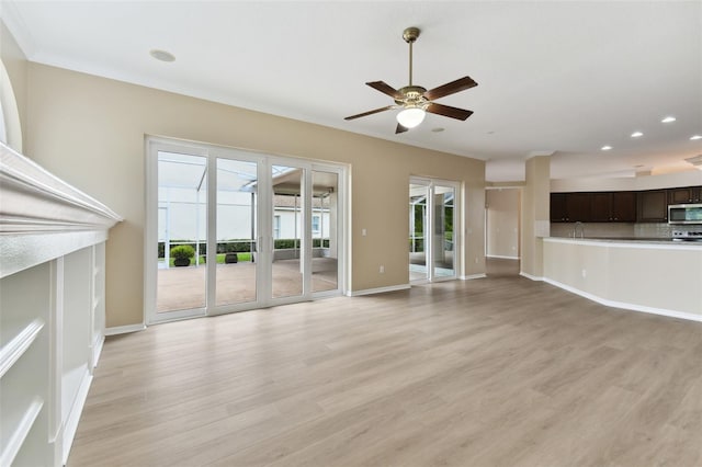 unfurnished living room with light wood-style flooring, baseboards, a ceiling fan, and recessed lighting