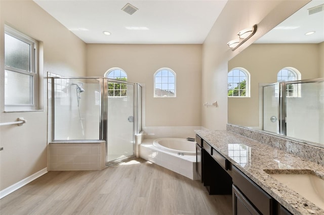 full bathroom featuring a stall shower, visible vents, and wood finished floors