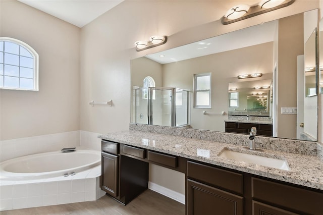 full bath featuring a shower stall, a bath, and vanity