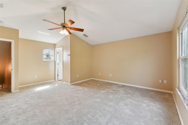 unfurnished room with lofted ceiling, a ceiling fan, visible vents, and light colored carpet