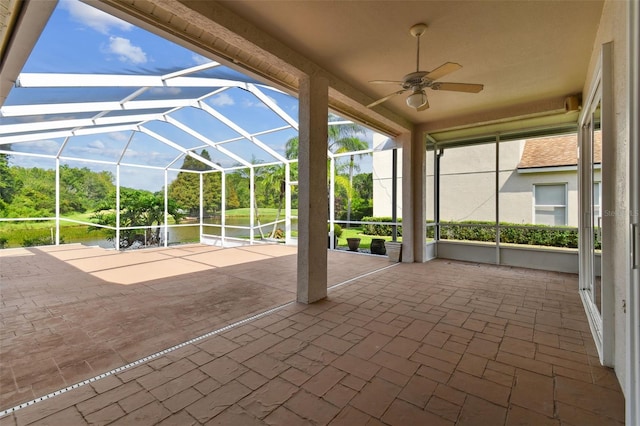 unfurnished sunroom featuring a ceiling fan