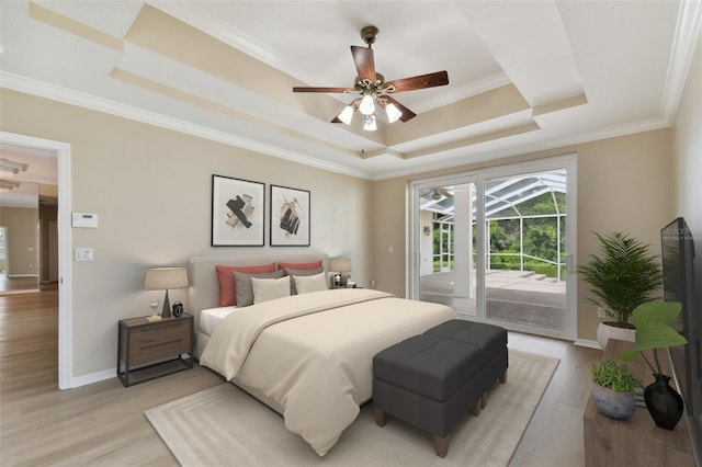 bedroom featuring access to exterior, crown molding, a raised ceiling, light wood-style flooring, and baseboards