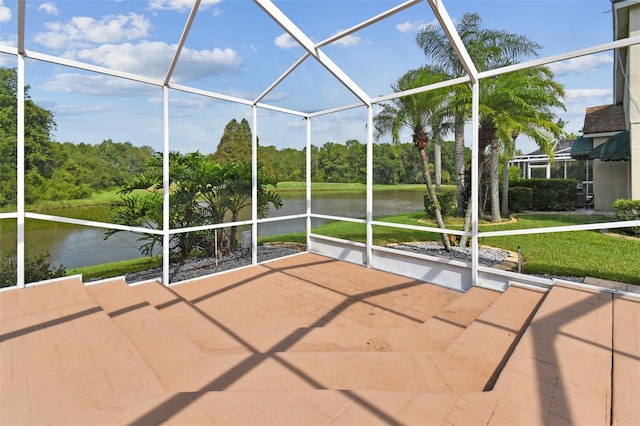 unfurnished sunroom featuring a water view