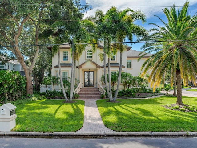 mediterranean / spanish house with a front yard