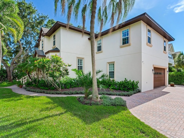 view of front of property with a front lawn and a garage