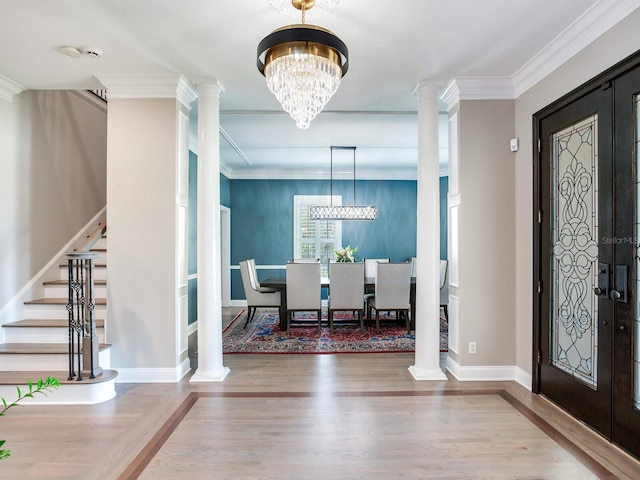 foyer with hardwood / wood-style flooring and ornate columns