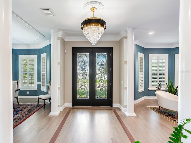 entryway with light hardwood / wood-style flooring, plenty of natural light, and crown molding