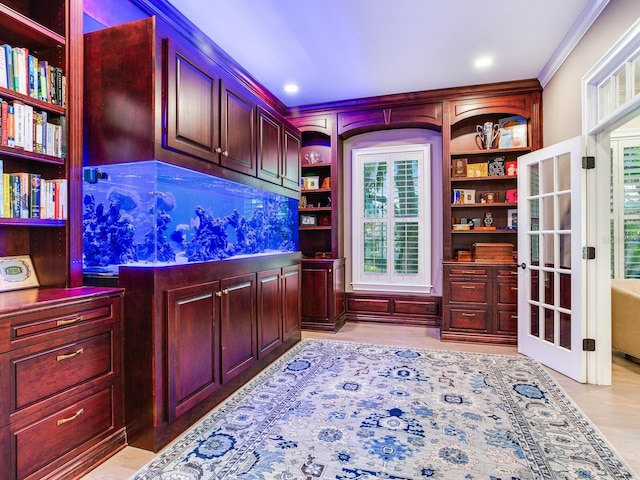 office area with light wood-type flooring and crown molding