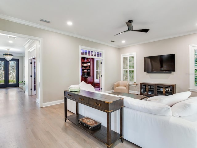 living room with ceiling fan, light hardwood / wood-style flooring, french doors, and a healthy amount of sunlight