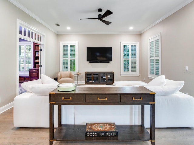 living room featuring light wood-type flooring, crown molding, and ceiling fan