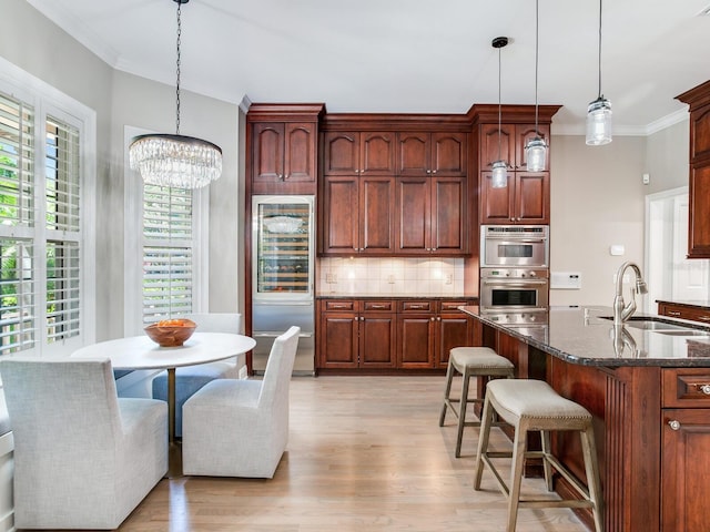 kitchen featuring light hardwood / wood-style flooring, tasteful backsplash, sink, and plenty of natural light