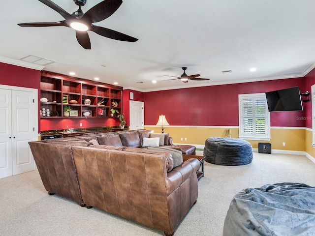 carpeted living room featuring built in features, crown molding, and ceiling fan