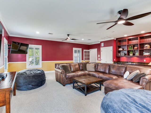 living room with light carpet, crown molding, and ceiling fan