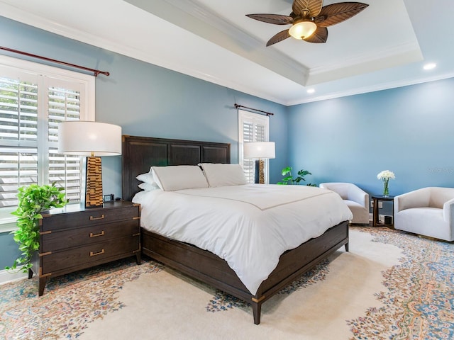 bedroom with ceiling fan, crown molding, and a raised ceiling