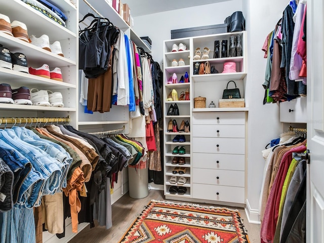 walk in closet with light wood-type flooring