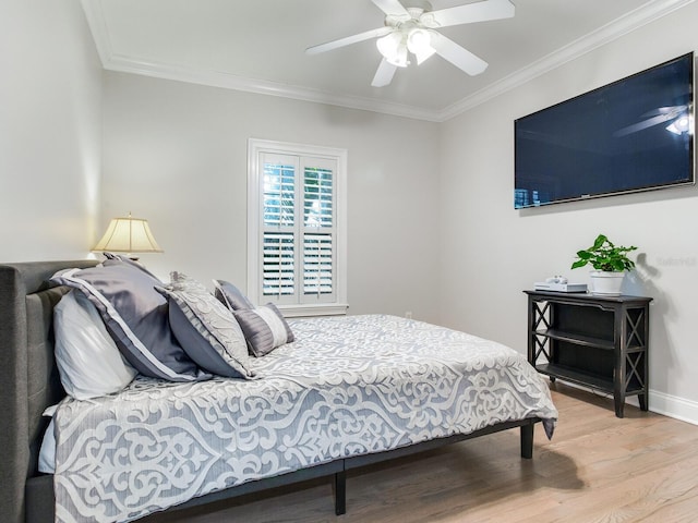 bedroom with ceiling fan, crown molding, and hardwood / wood-style flooring