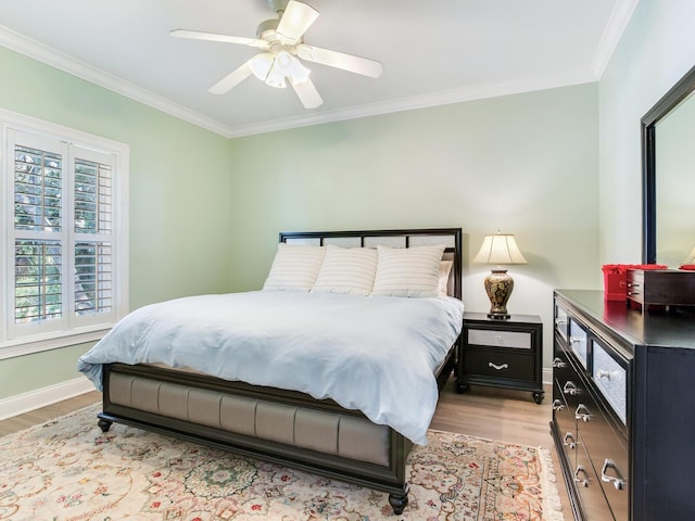 bedroom featuring ceiling fan, light hardwood / wood-style flooring, and ornamental molding