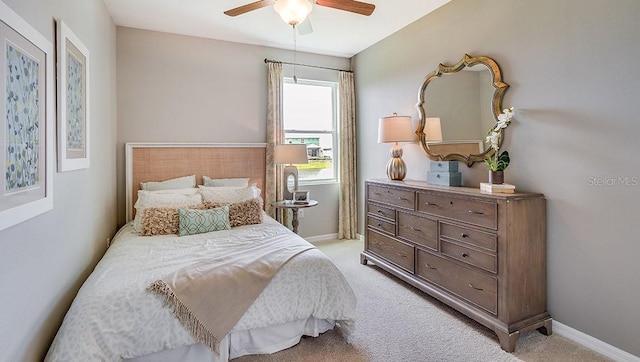 bedroom with ceiling fan and light colored carpet