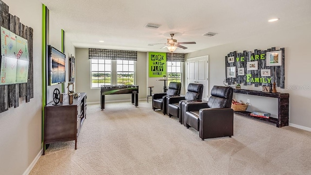 living room featuring light colored carpet and ceiling fan