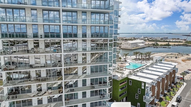 view of property featuring a water view and a community pool