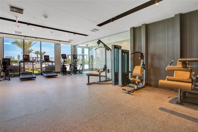 exercise room featuring floor to ceiling windows and visible vents