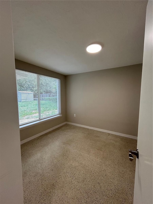 empty room featuring baseboards