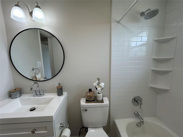 full bathroom with vanity, tiled shower / bath combo, and toilet