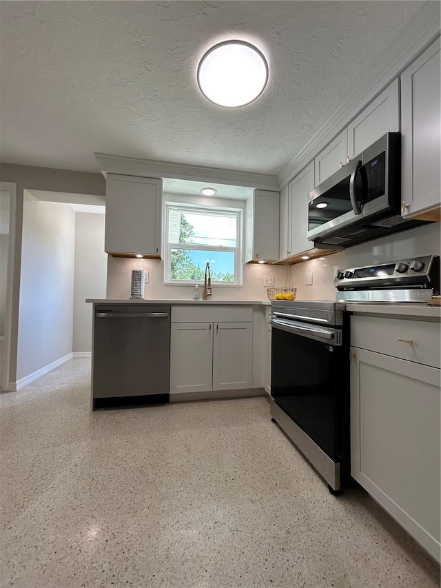 kitchen featuring appliances with stainless steel finishes, a textured ceiling, and sink