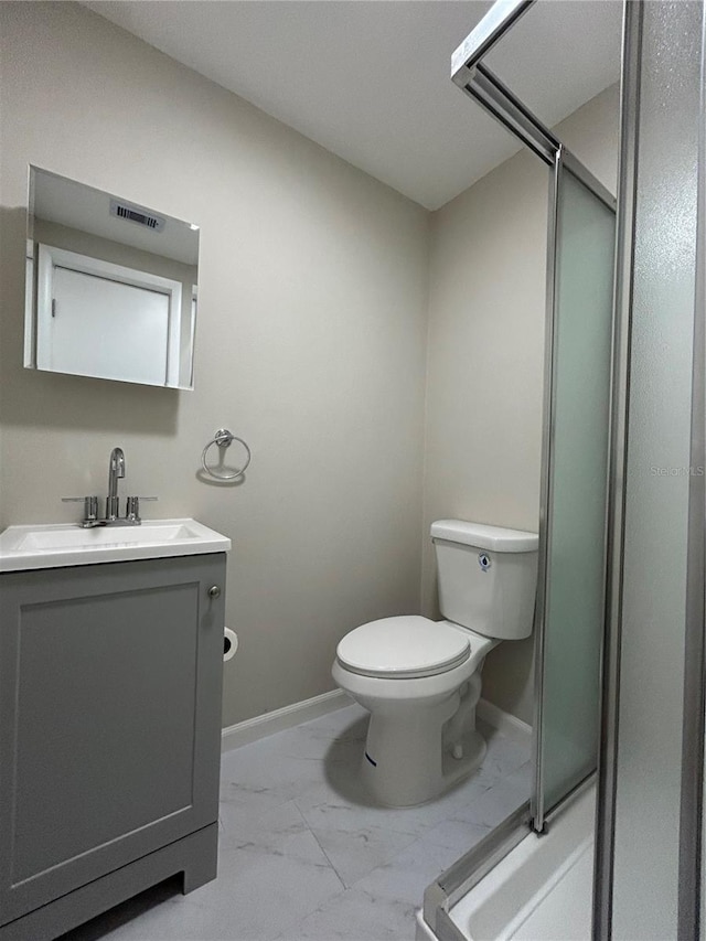 bathroom with vanity, toilet, and walk in shower