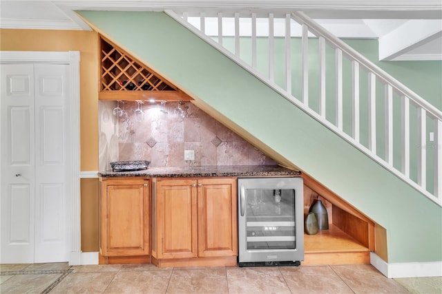 bar featuring backsplash, light tile patterned flooring, ornamental molding, and wine cooler