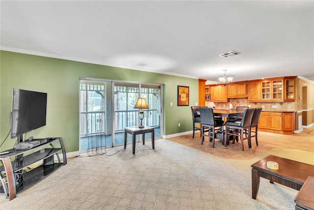 dining room featuring crown molding and a notable chandelier