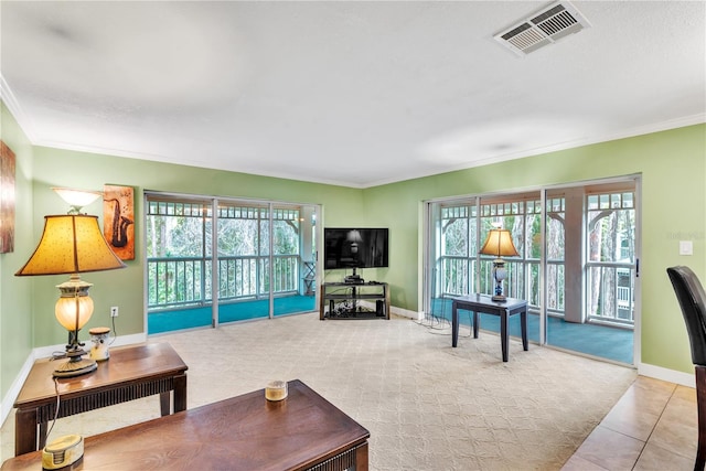 living room featuring light colored carpet, crown molding, and a wealth of natural light