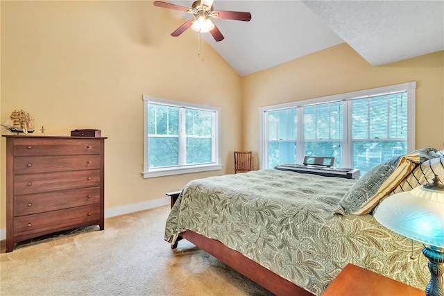 carpeted bedroom with ceiling fan and high vaulted ceiling