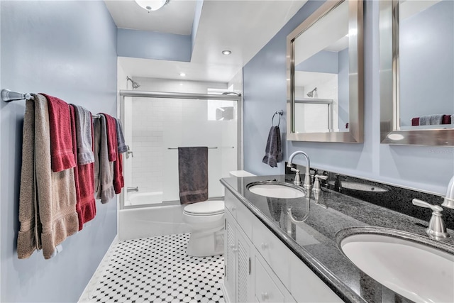 full bathroom featuring vanity, tile patterned flooring, toilet, and combined bath / shower with glass door