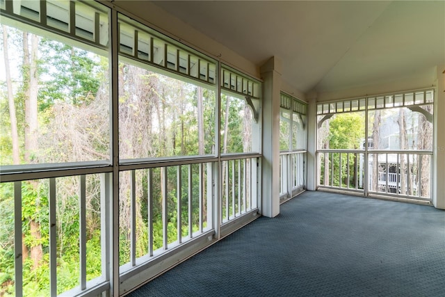 unfurnished sunroom with vaulted ceiling